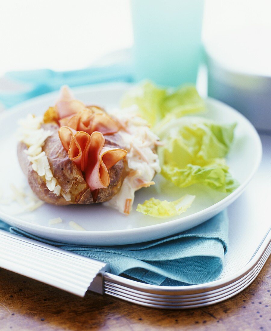 Baked potato with cheese, ham and herb fillings