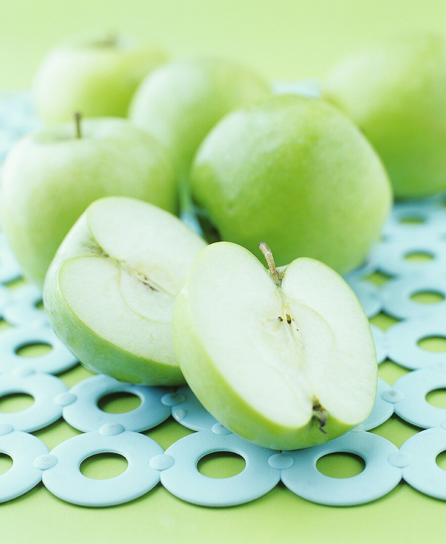 Green apples, whole and halved