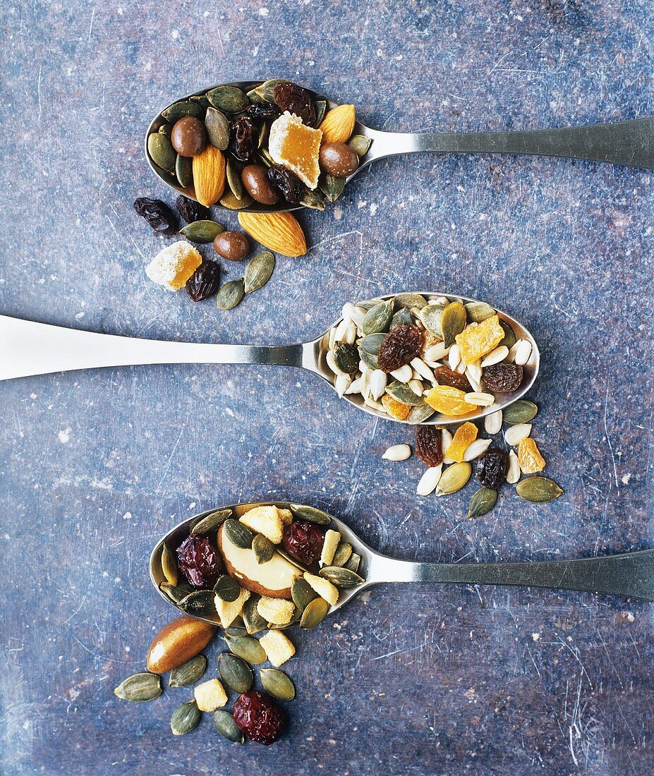 Mixed nuts and dried fruit on three spoons