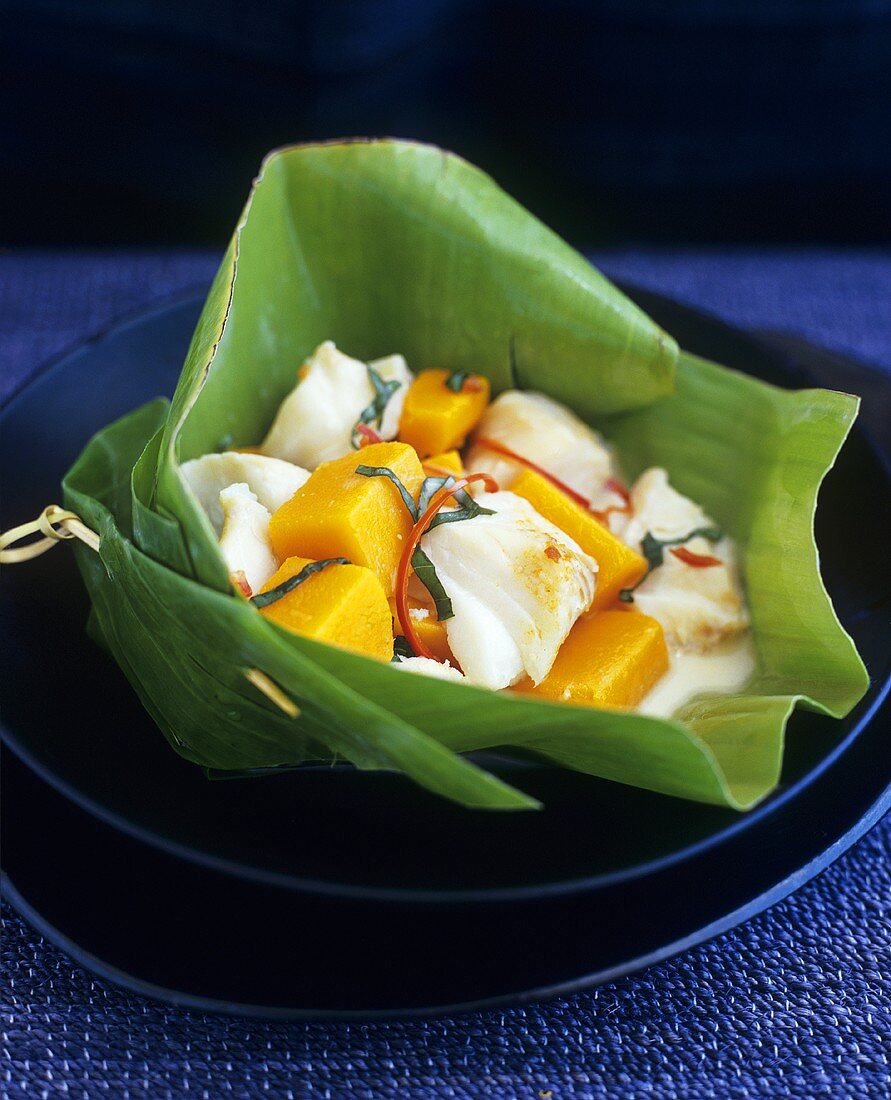 Fish and pumpkin curry with chilli in a banana leaf