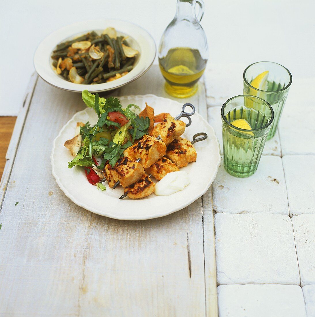 Grilled chicken kebabs with salad and beans