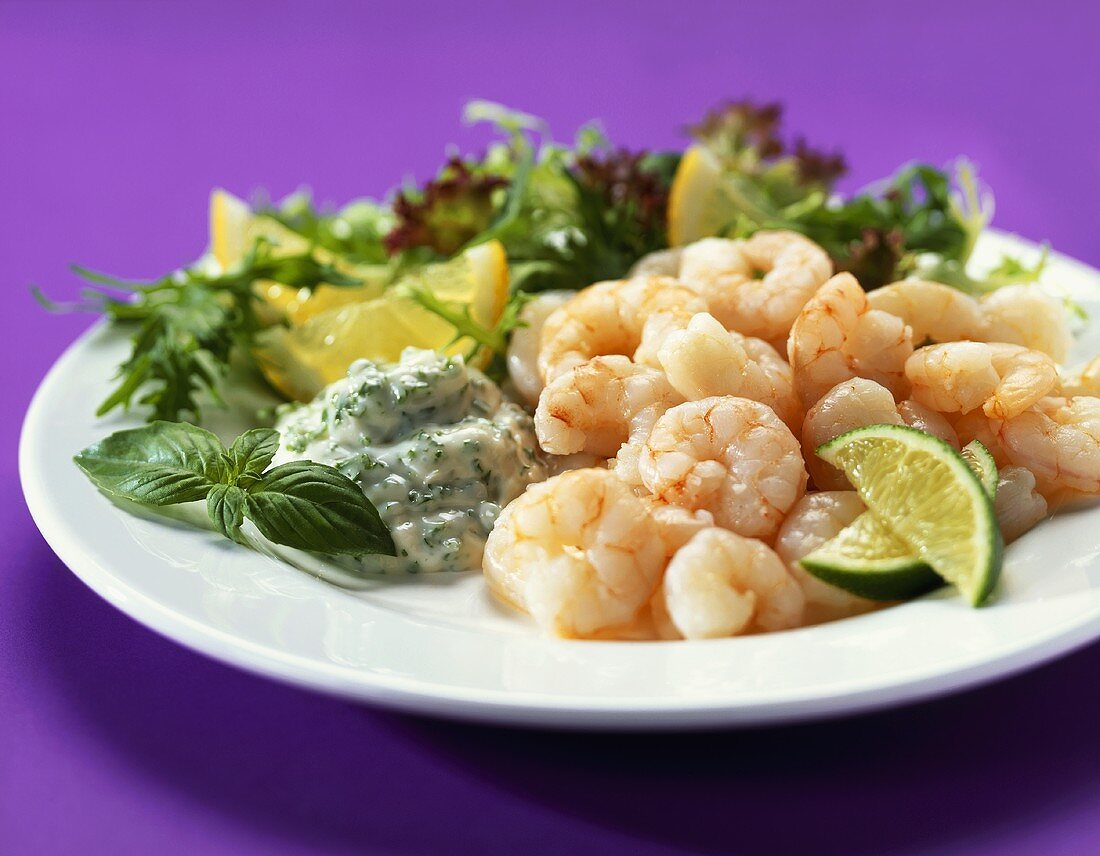 Peeled shrimps with dip and salad