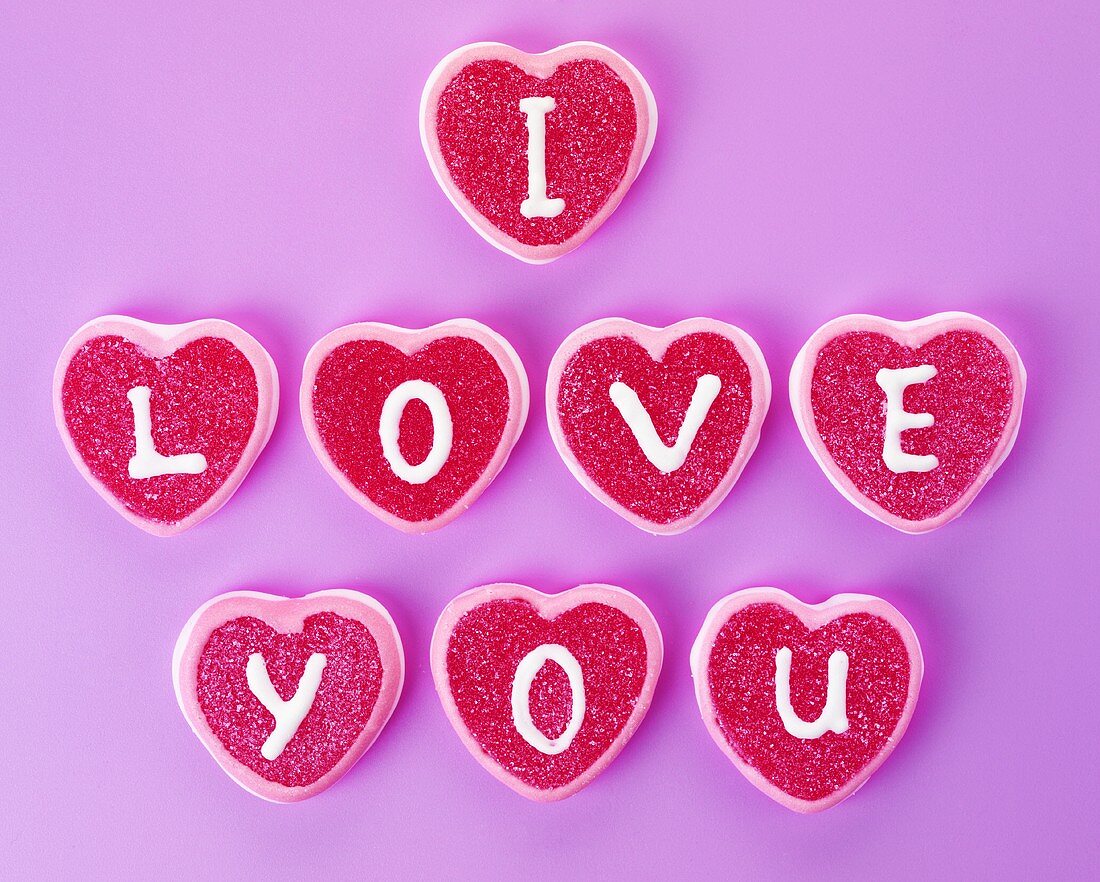 Heart-shaped sweets with letters spelling 'I love you'