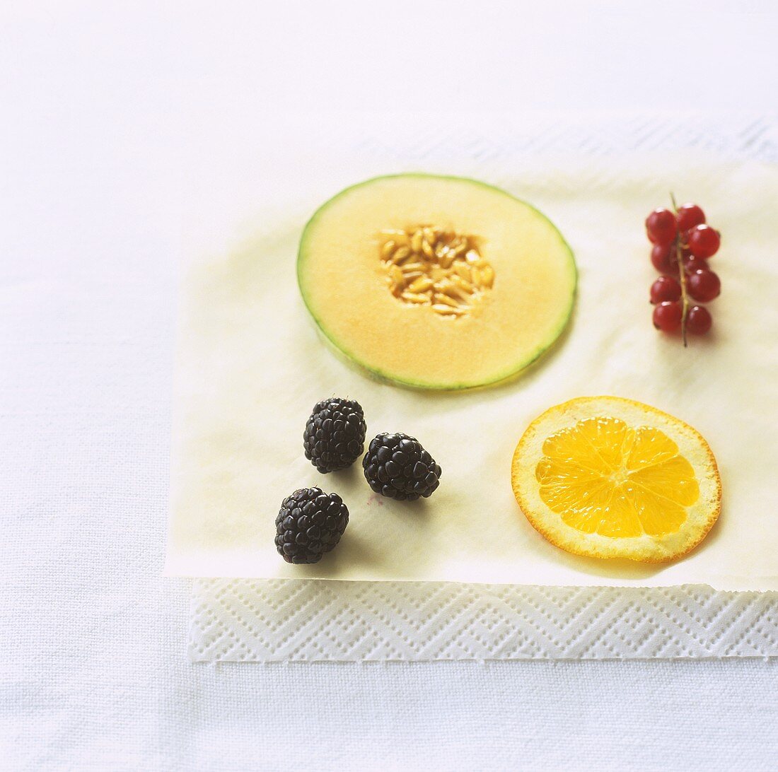 Blackberries, slice of orange, slice of melon & redcurrants