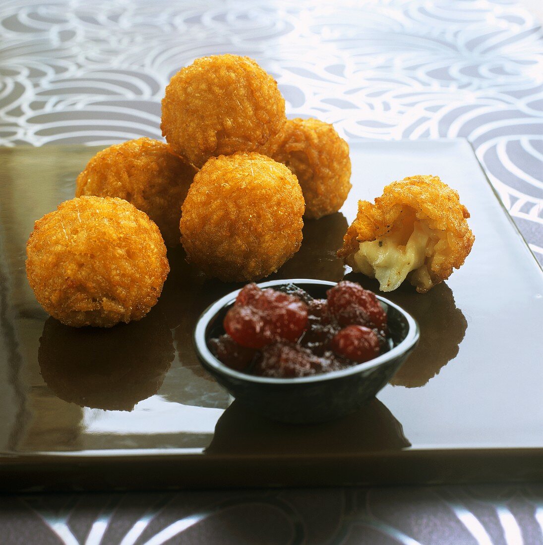 Deep-fried mozzarella risotto balls with cranberry sauce