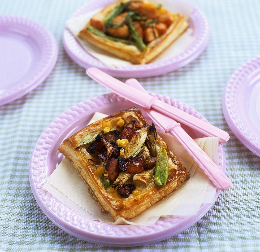 Puff pastry vegetable tartlet with pink plastic cutlery