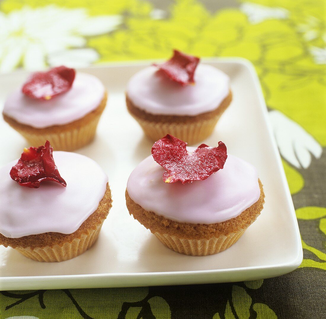 Iced cupcakes with rose petals
