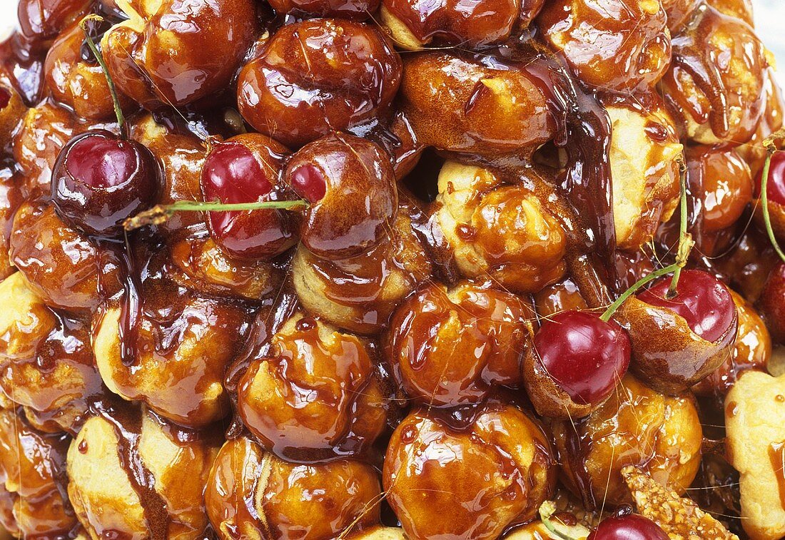Profiteroles with caramel sauce and cherries (detail)