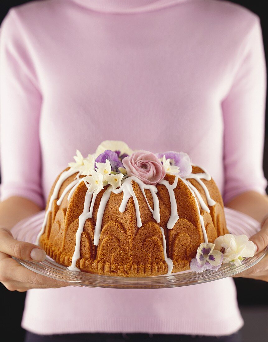 Sponge cake decorated with icing and flowers