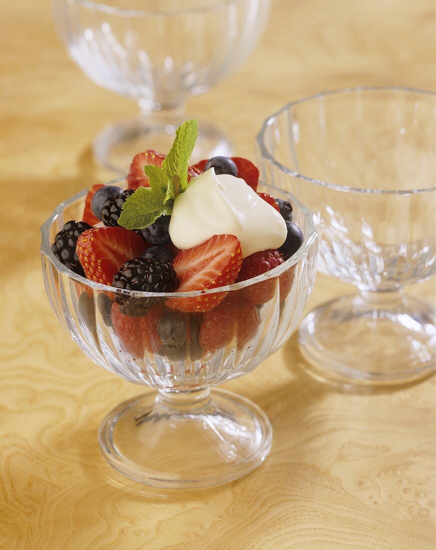 Fresh summer berries with crème fraîche in dessert glass