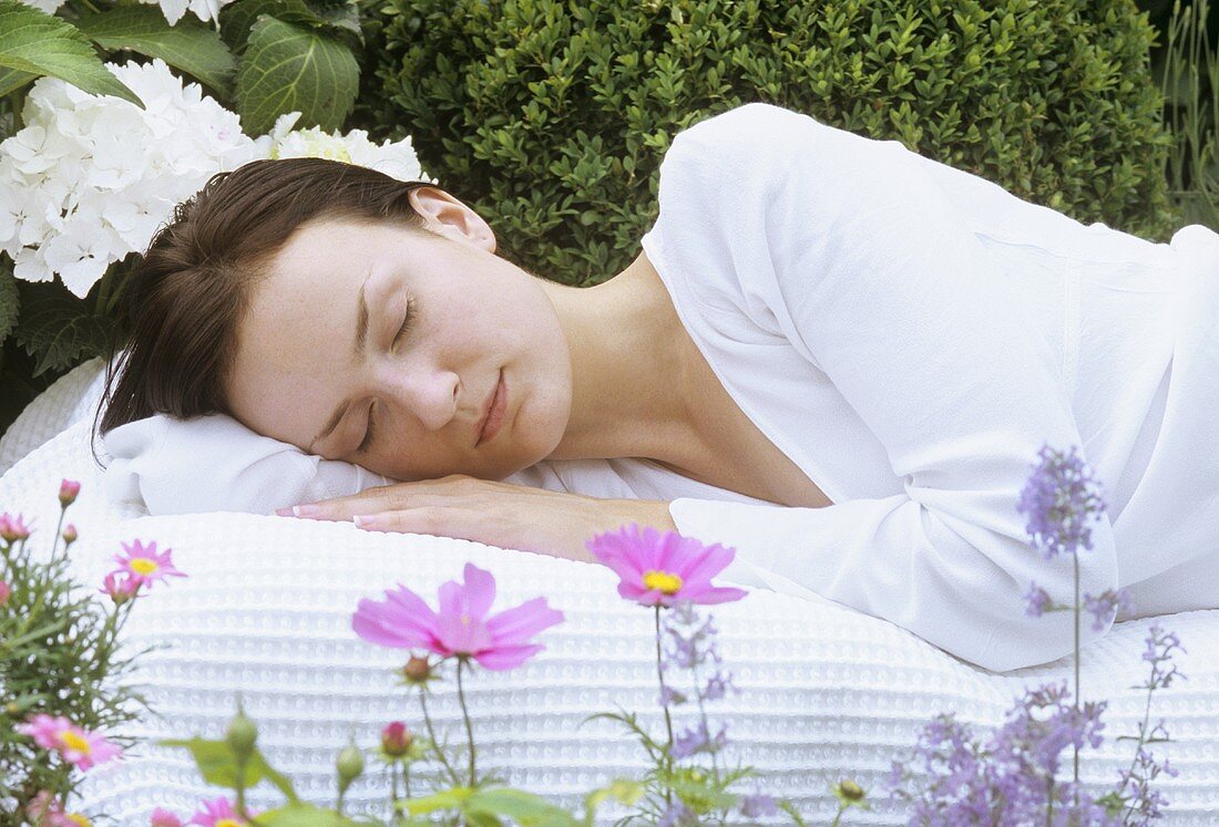 Young woman asleep in garden