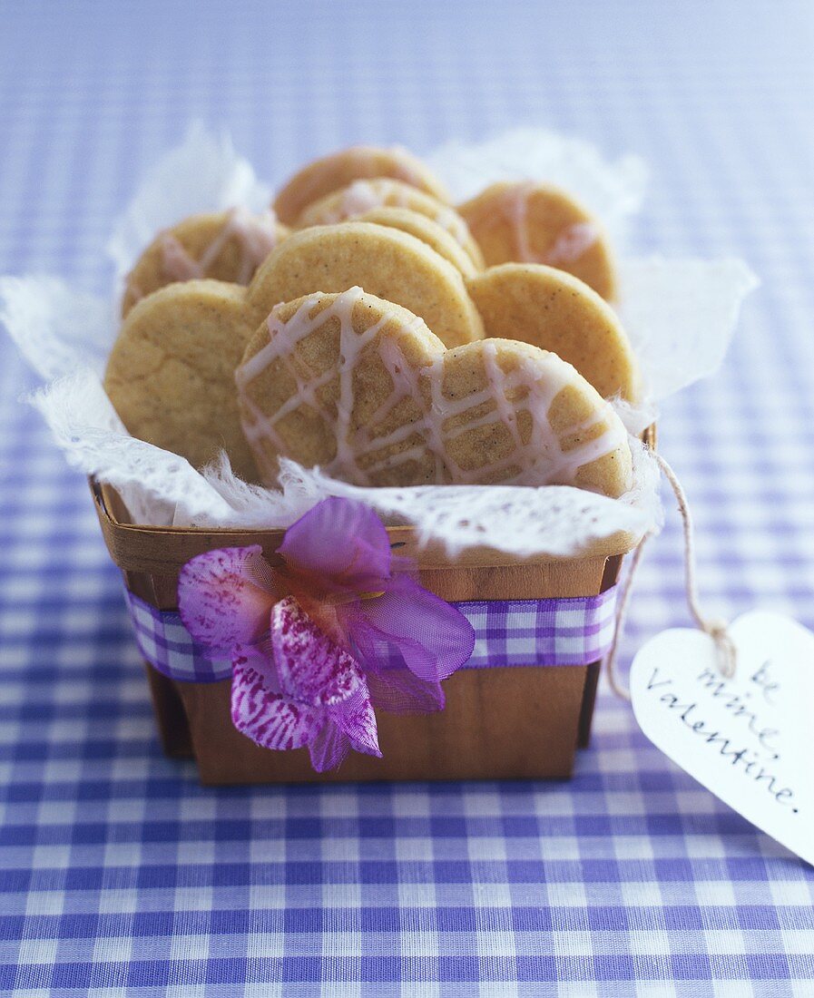 Heart-shaped biscuits in small basket with Valentine gift tag