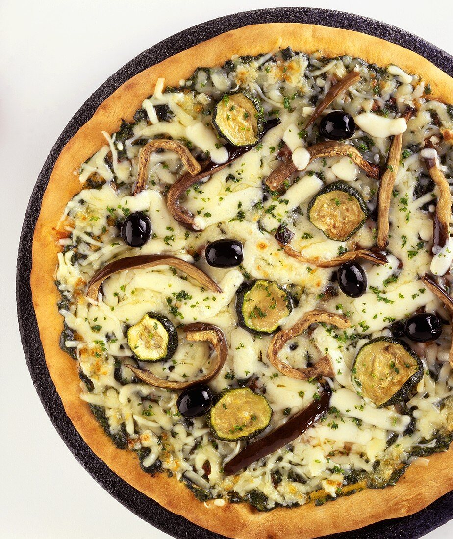 Vegetable pizza with aubergines, courgettes, olives & cheese
