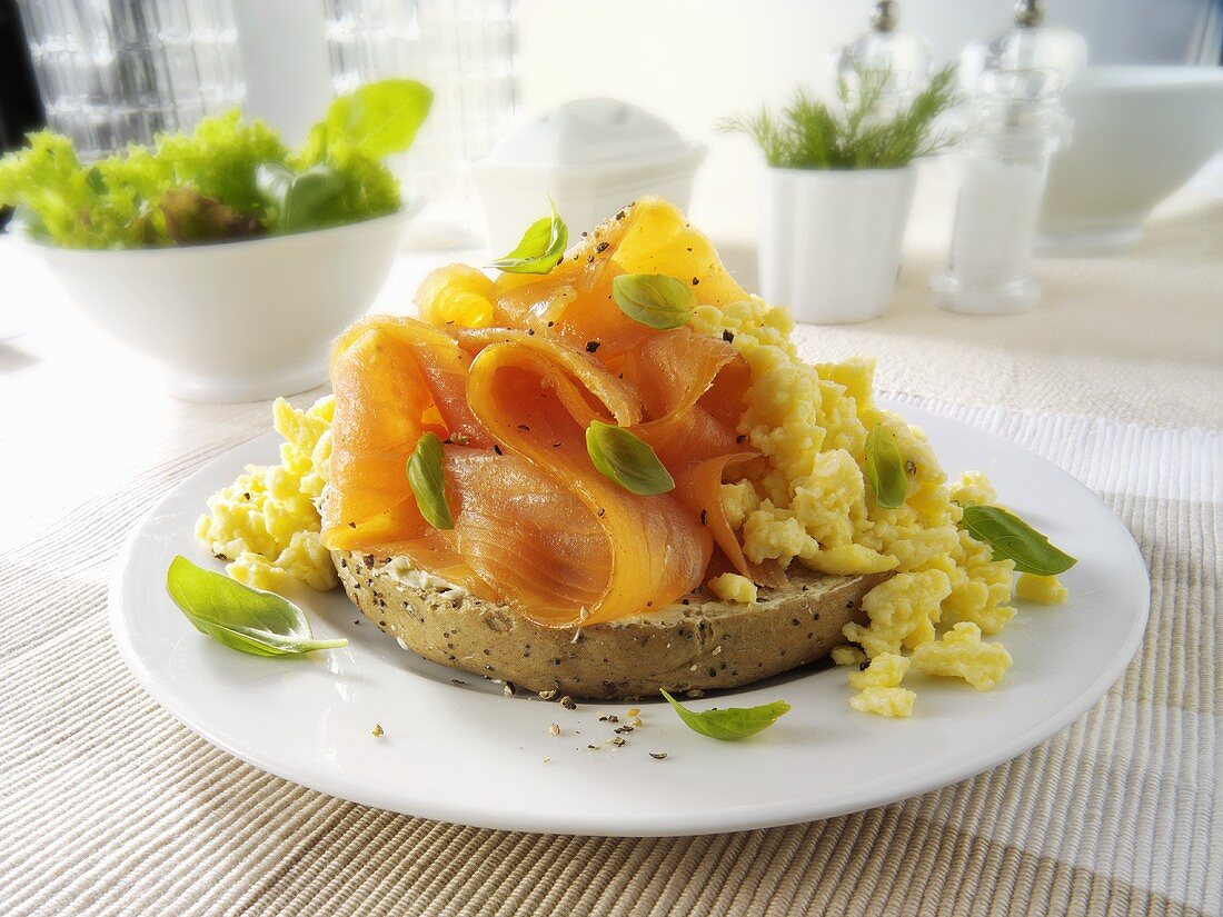Bagel topped with scrambled egg and smoked salmon