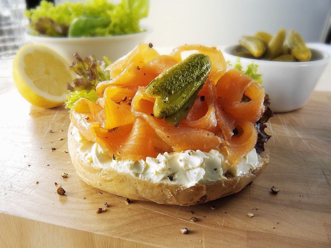 Bagel topped with cream cheese, smoked salmon and gherkin