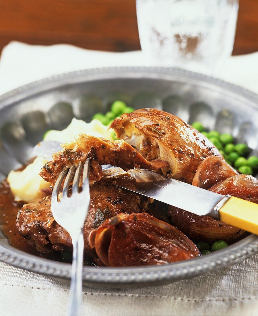 Coq au vin with mashed potato and peas