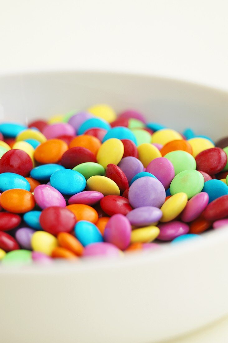 Small bowl of coloured chocolate beans