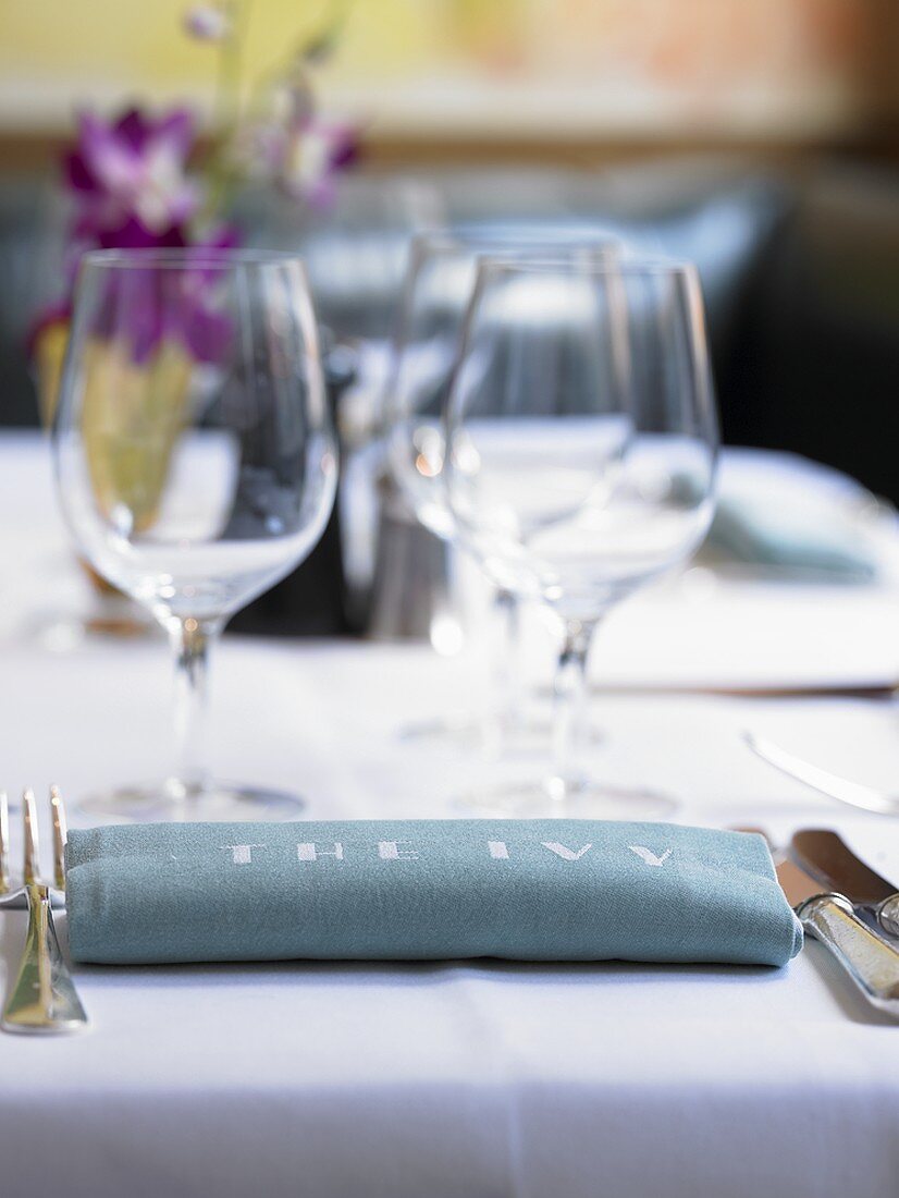 Place-setting with 'The Ivy' on napkin