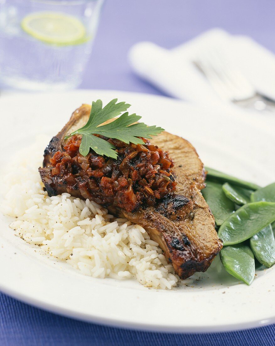Pork chop with spicy tomato relish on rice