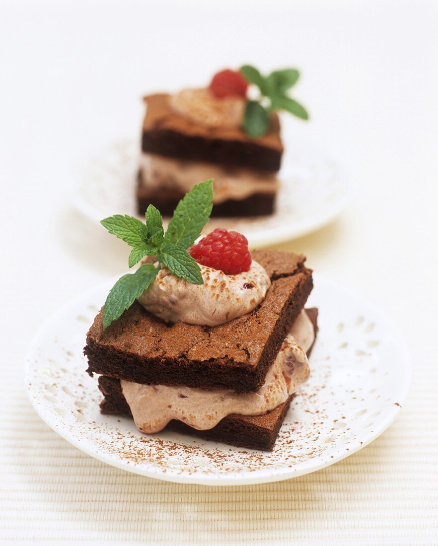 Small chocolate sponge cakes filled with raspberry cream