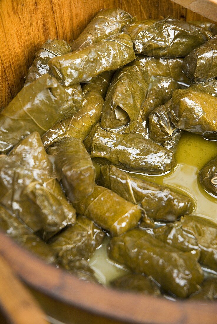 Stuffed vine leaves in wooden container on market stall