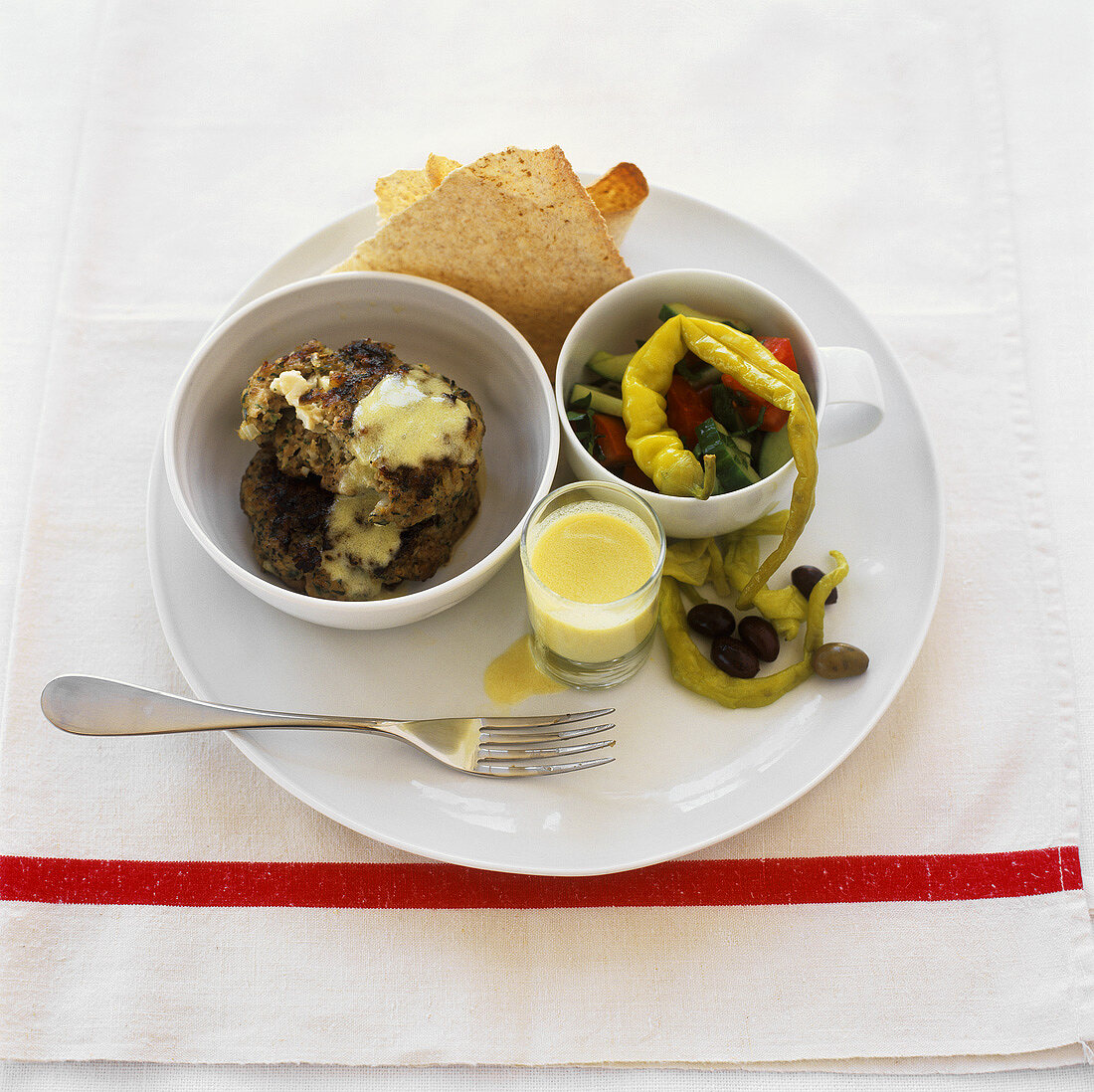 Mince and feta patties with sauce and vegetable salad