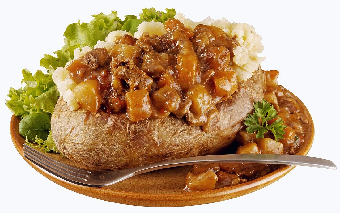 A baked potato with beef sauce