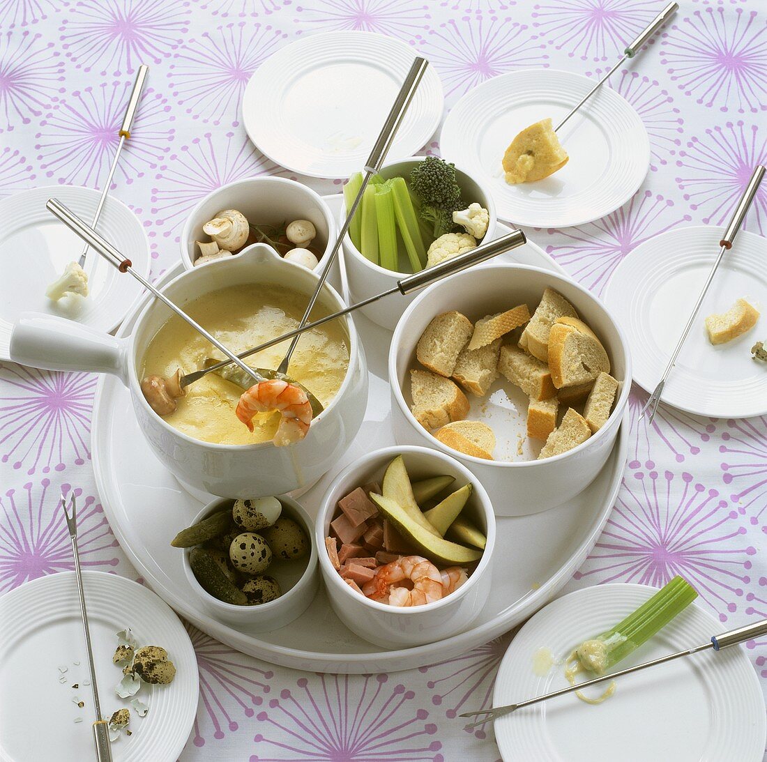 Cheese fondue with vegetables, prawns and bread cubes