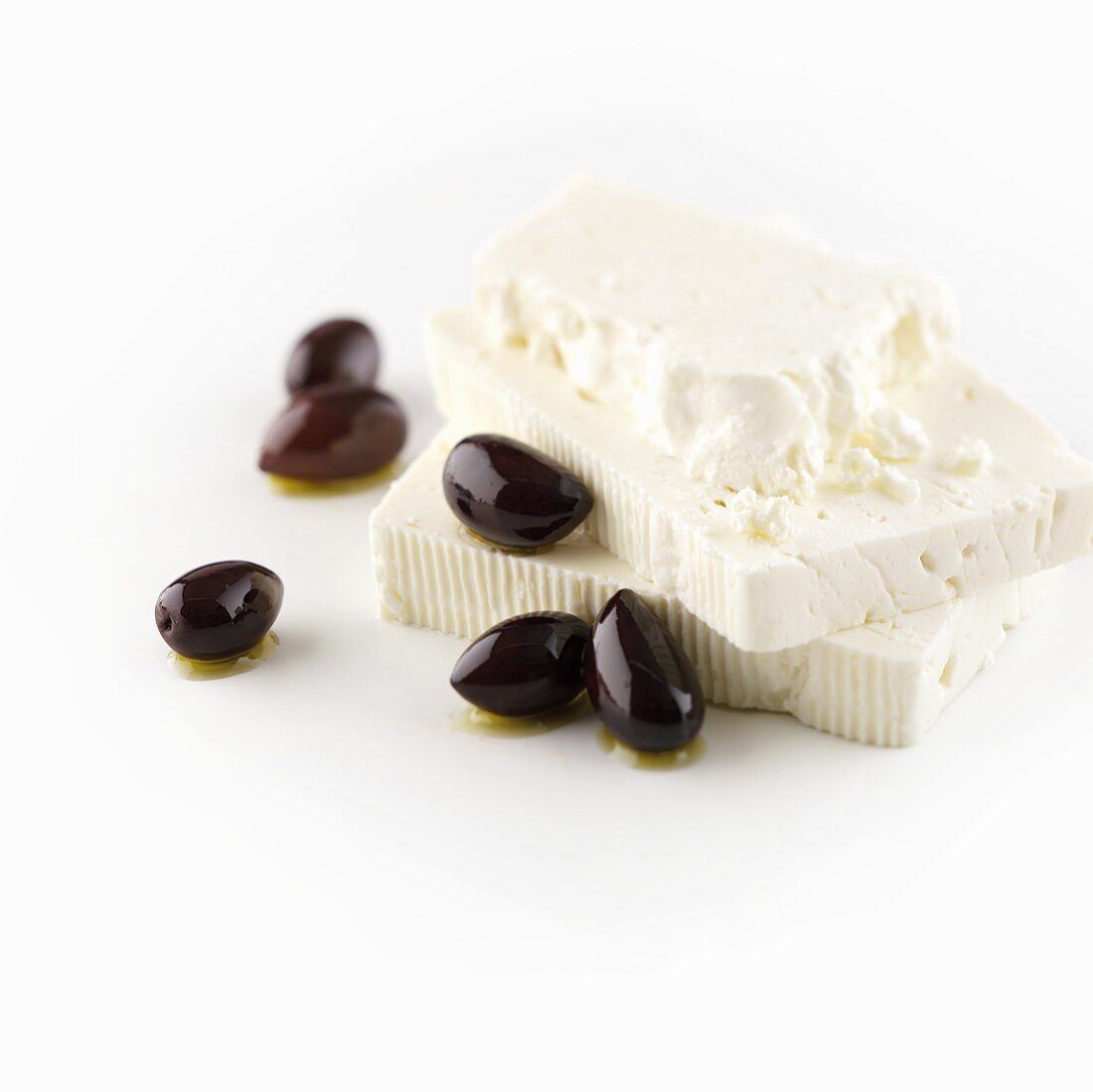 Slices of feta cheese with black olives