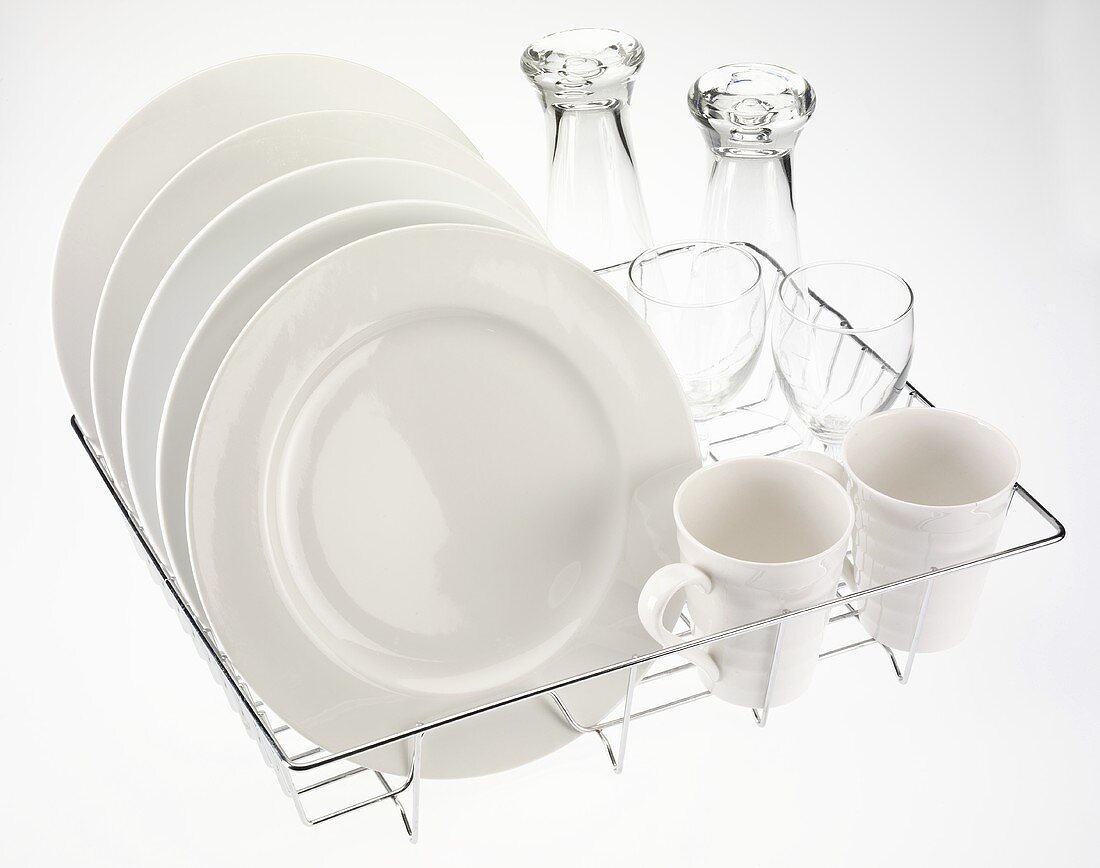 Plates, cups and glasses on dish rack