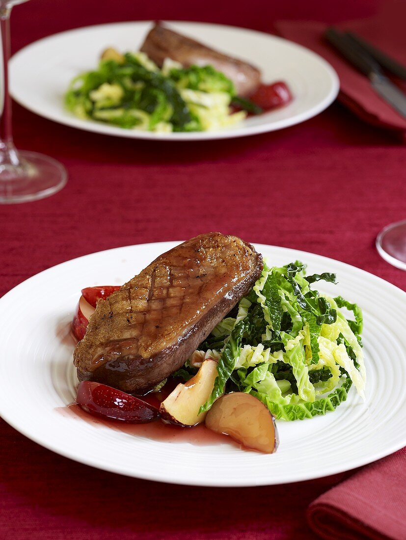 Duck breast on savoy cabbage with plums