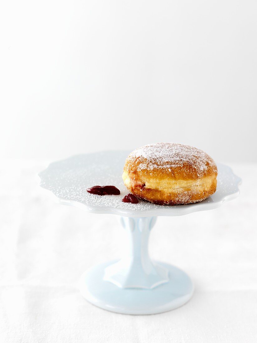 A doughnut with a blob of jam