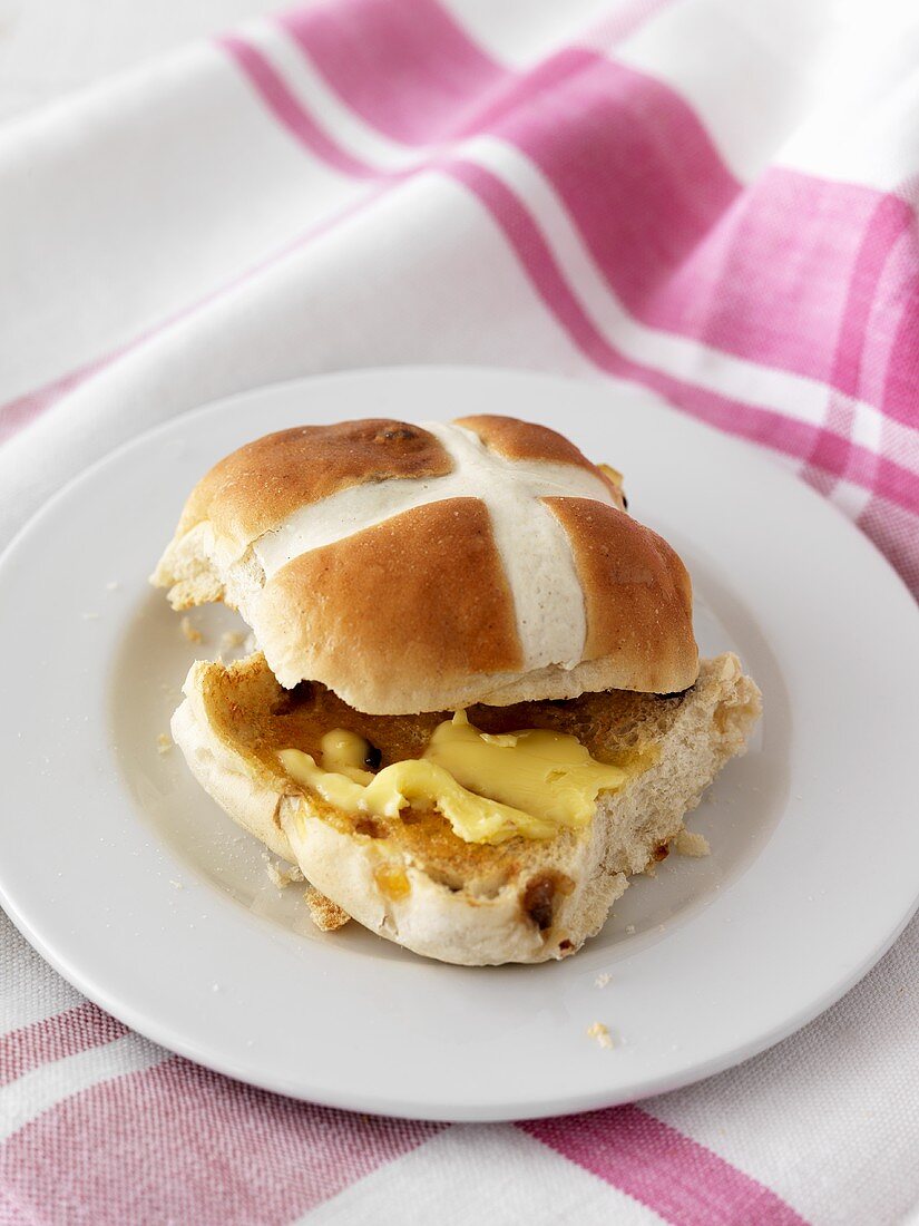 Buttered hot cross bun