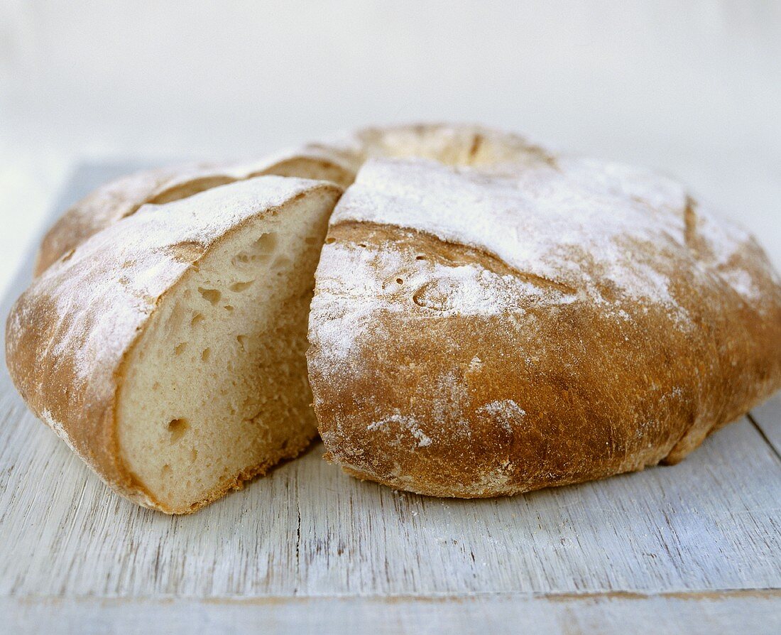 Round white loaf, a wedge cut