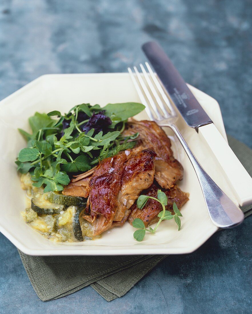 Pork ribs with courgettes and salad garnish