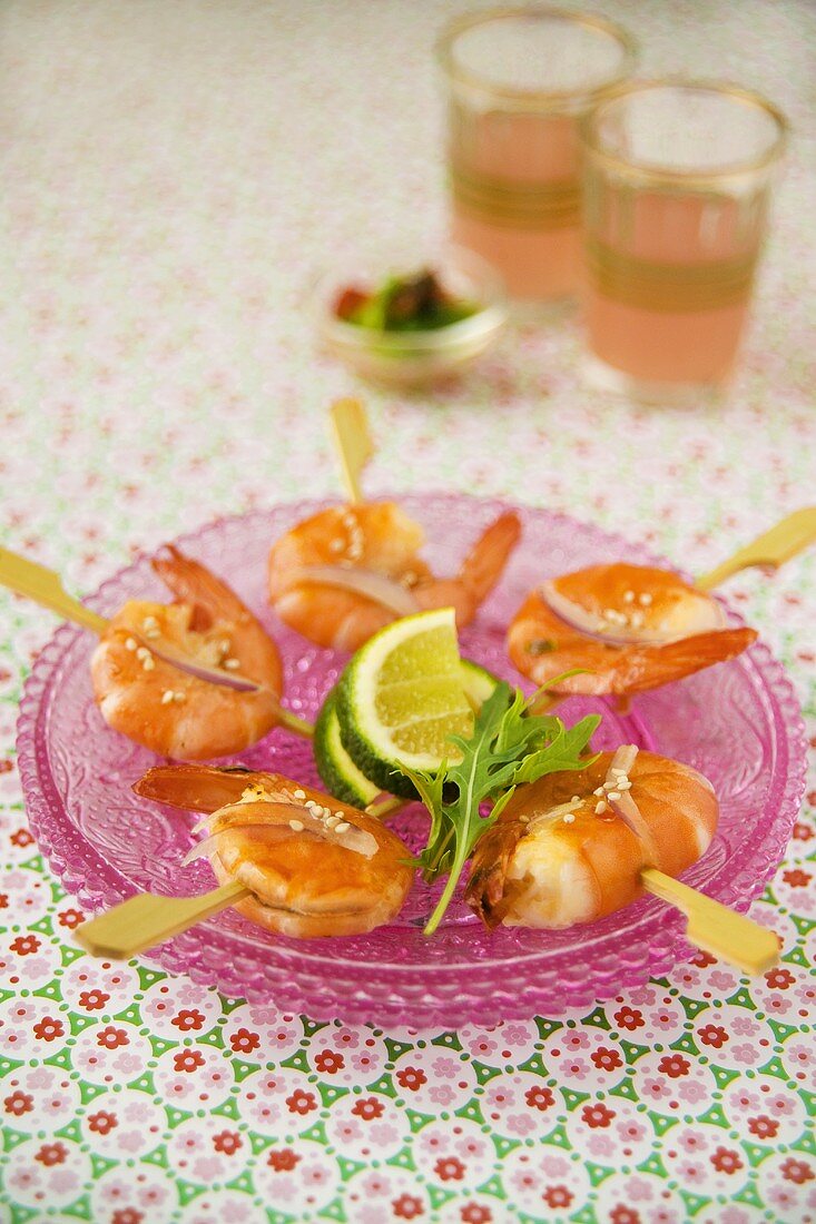 Fried shrimps on cocktail sticks with lime