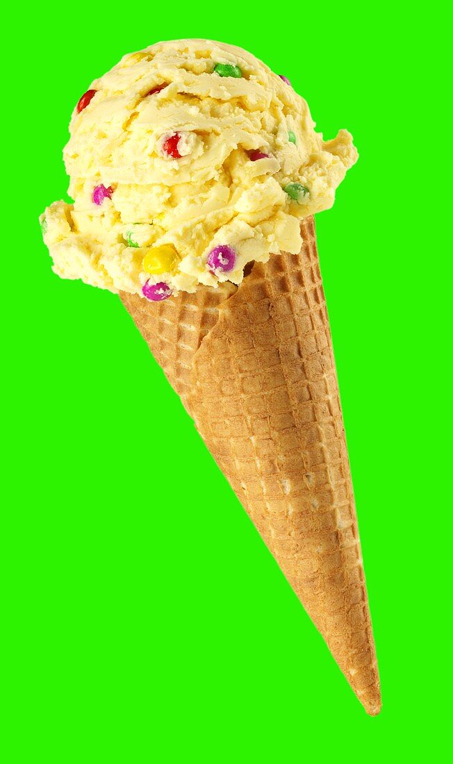 Fruit ice cream with sprinkles in ice cream cone