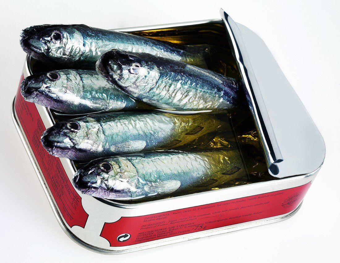 Sardines poking out of opened tin