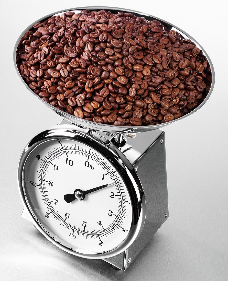 Roasted coffee beans on kitchen scales