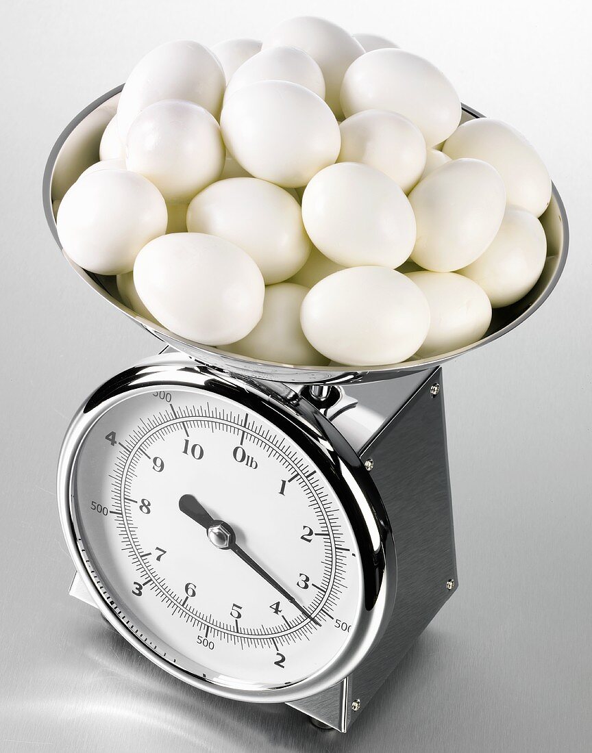 Hard-boiled eggs on kitchen scales