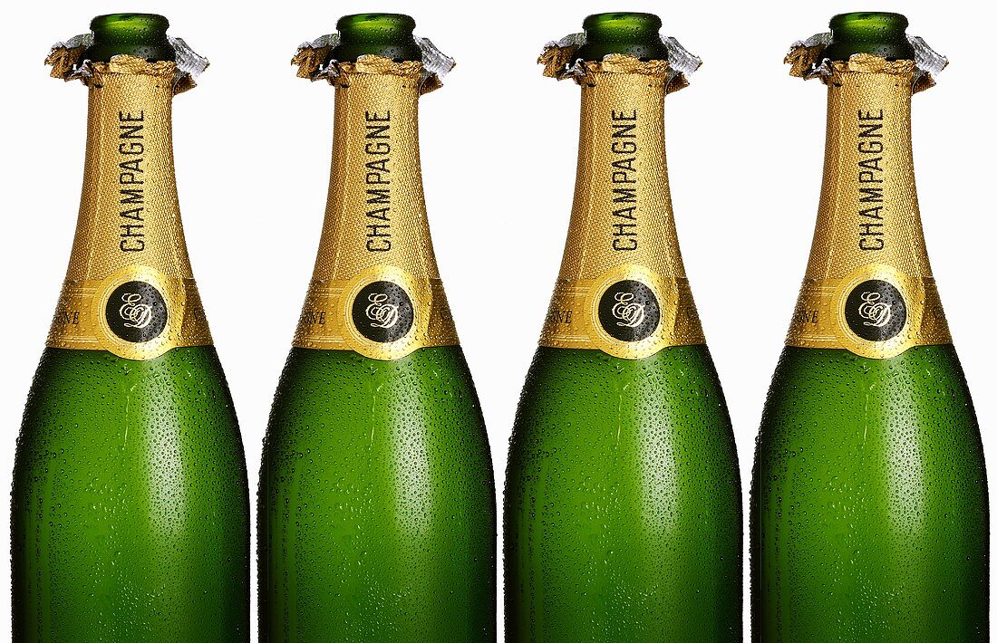 Four opened champagne bottles