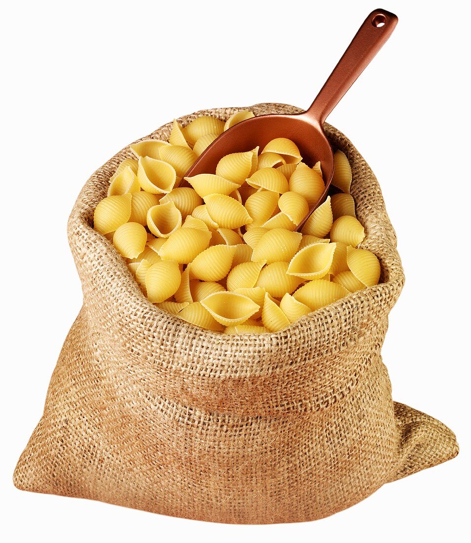 Pasta shells in jute sack with scoop
