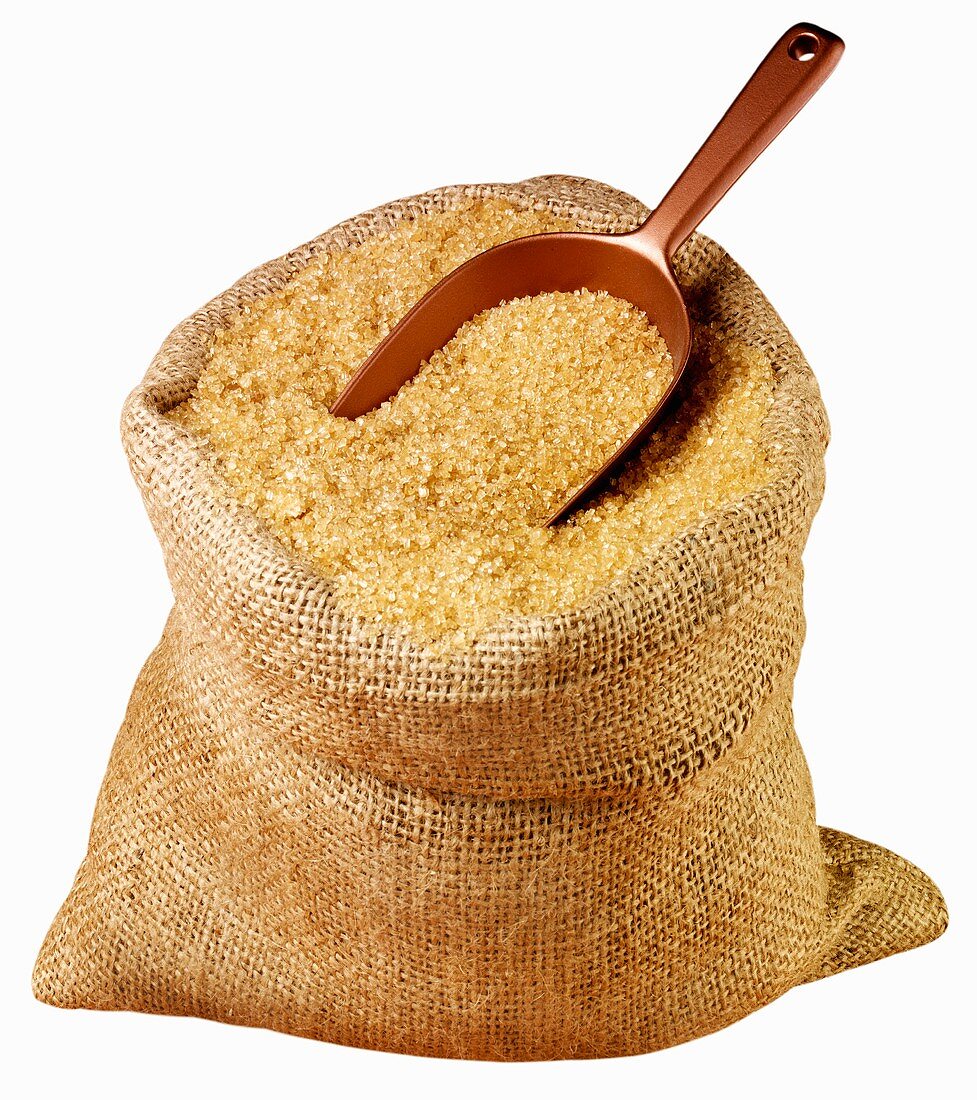 Demerara sugar in jute sack with scoop