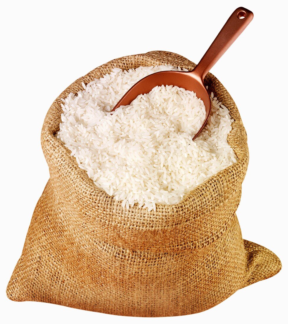 Long-grain rice in jute sack with scoop