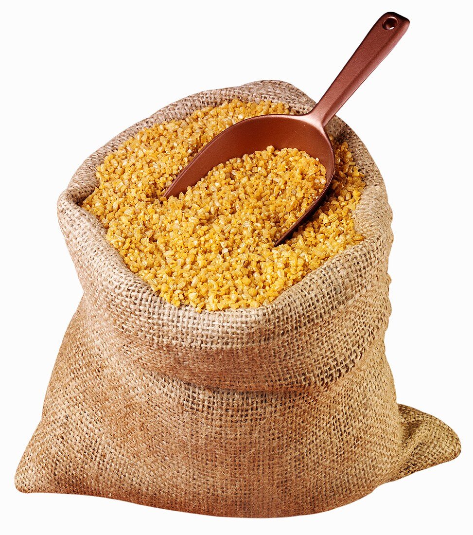 Bulgur wheat in jute sack with scoop