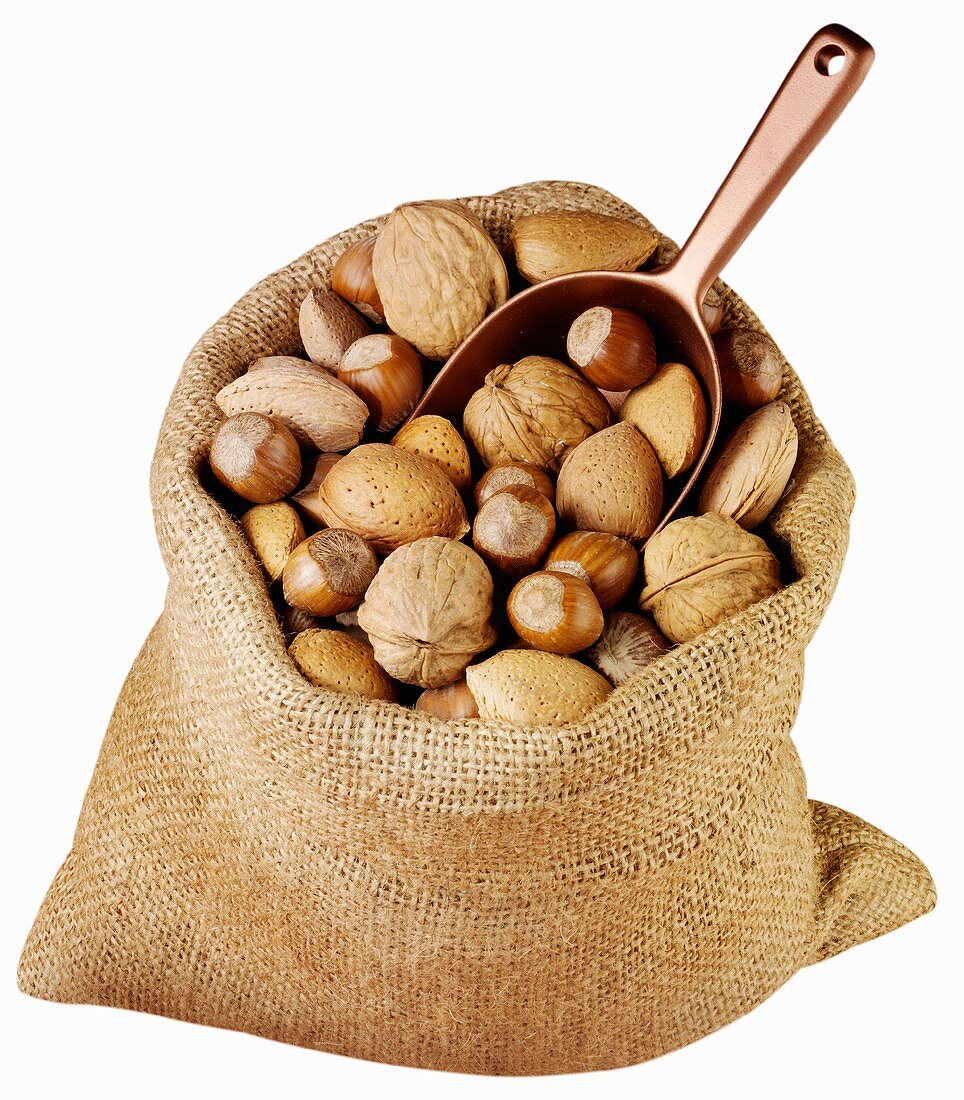 Assorted nuts in jute sack with scoop