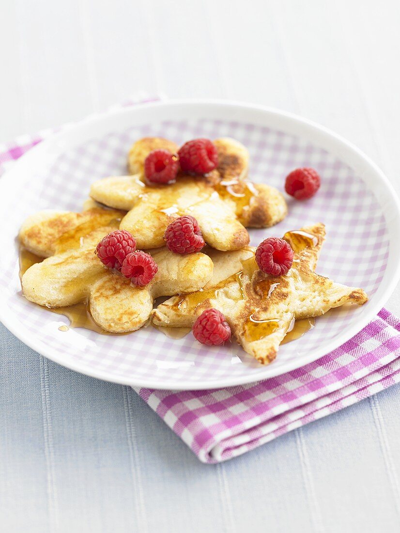 Star- and flower-shaped pancakes with raspberries