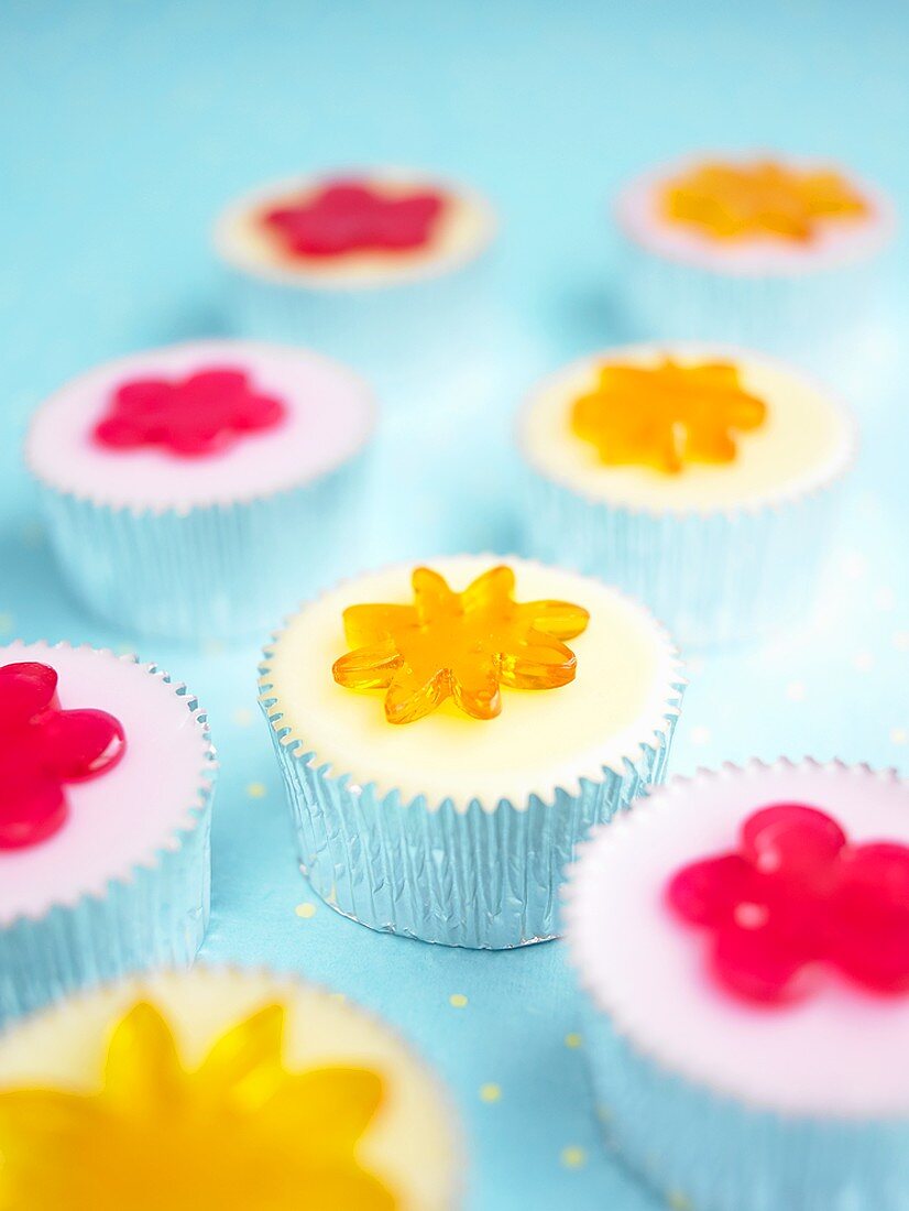 Iced cupcakes with jelly flowers