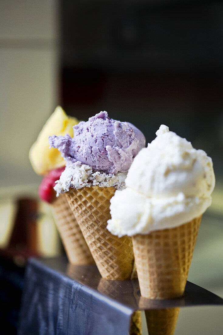 Three cones of different flavoured ice cream