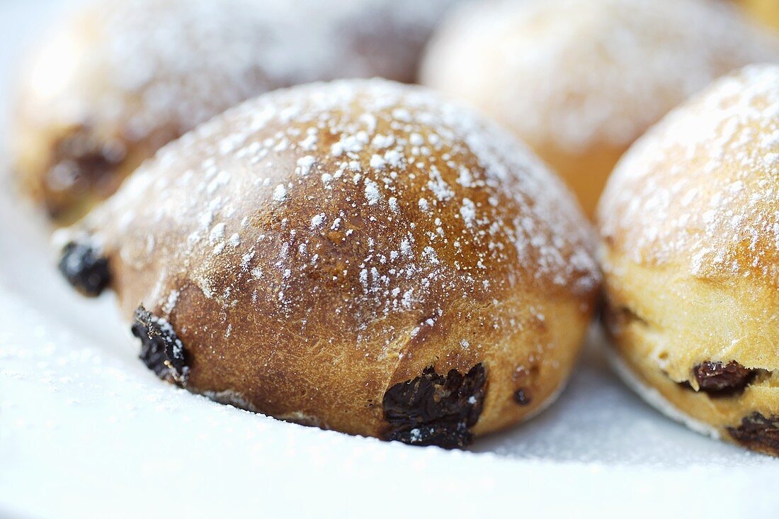 Raisin buns sprinkled with icing sugar